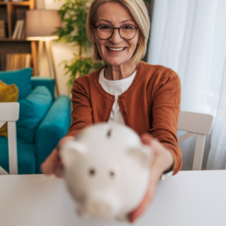 person smiling with piggy bank