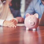 A pink piggybank on top of a table