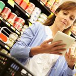 A price-conscious shopper looks for deals at the grocery store.
