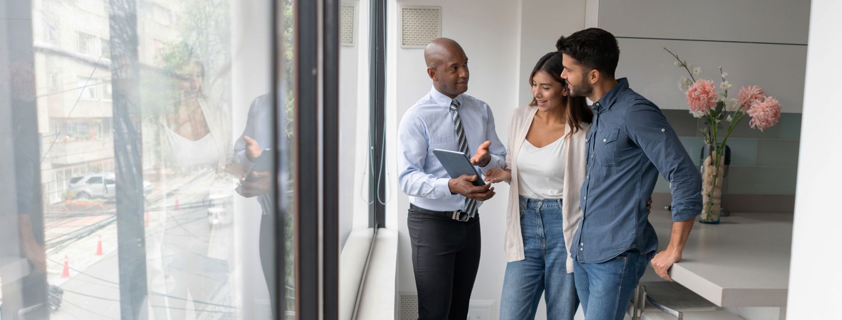 A couple tours a home with their real estate agent.