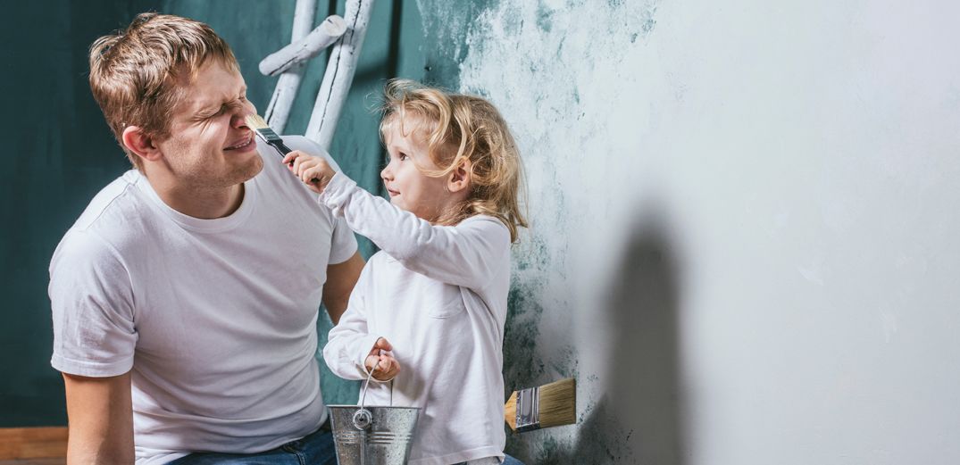 A toddler paints her dad's nose in the middle of a home improvement project funded by a home equity loan from Patelco.