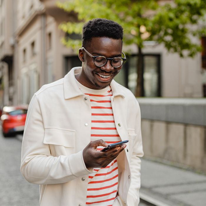 A Millennial uses Patelco Online on his phone to keep track of his bank accounts.