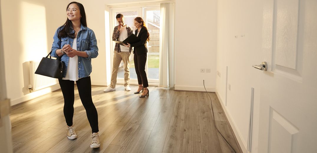 Potential homebuyers tour a house.