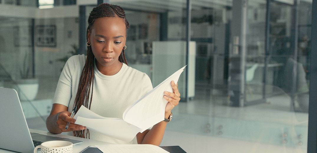 A woman reviews her credit card statements.