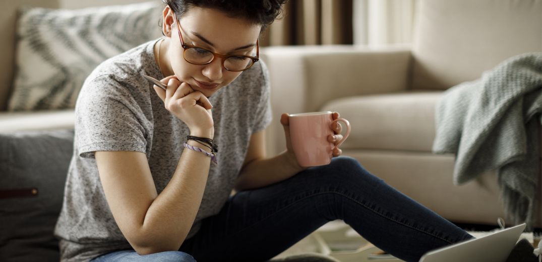 A Gen Z woman uses the Patelco Mobile App to access her credit card statement.