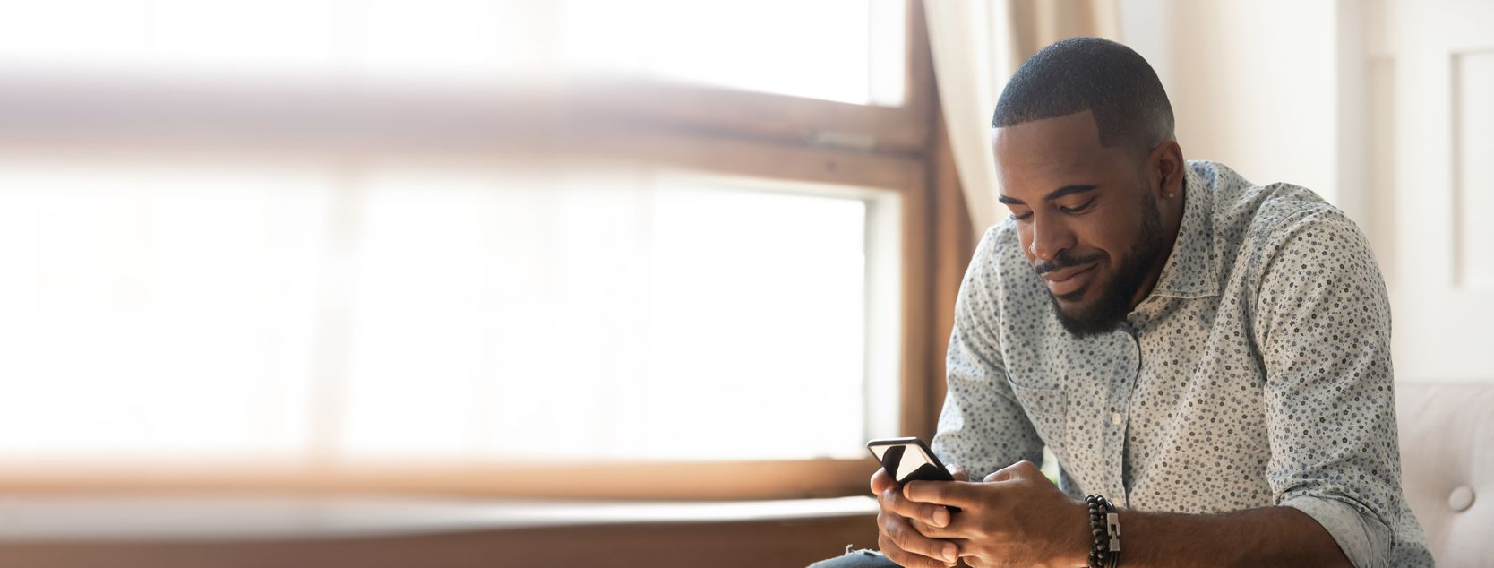 A Patelco member uses his phone to move money between his accounts.