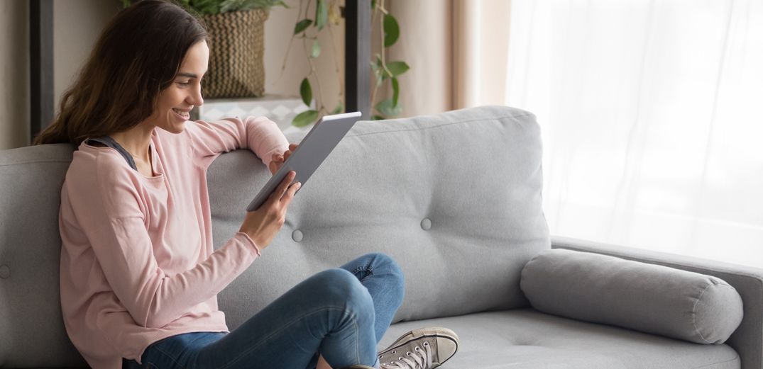 A woman sets up homeowners insurance from her tablet.
