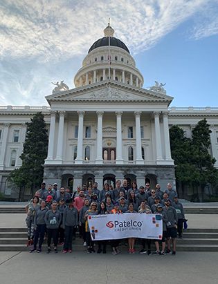 Patelco team members at the Credit Union for Kids Sactown Run event photo with the capitol in the background