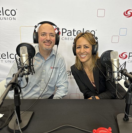 Patelco employees Michele Enriquez and Luis Jara at the podcast desk