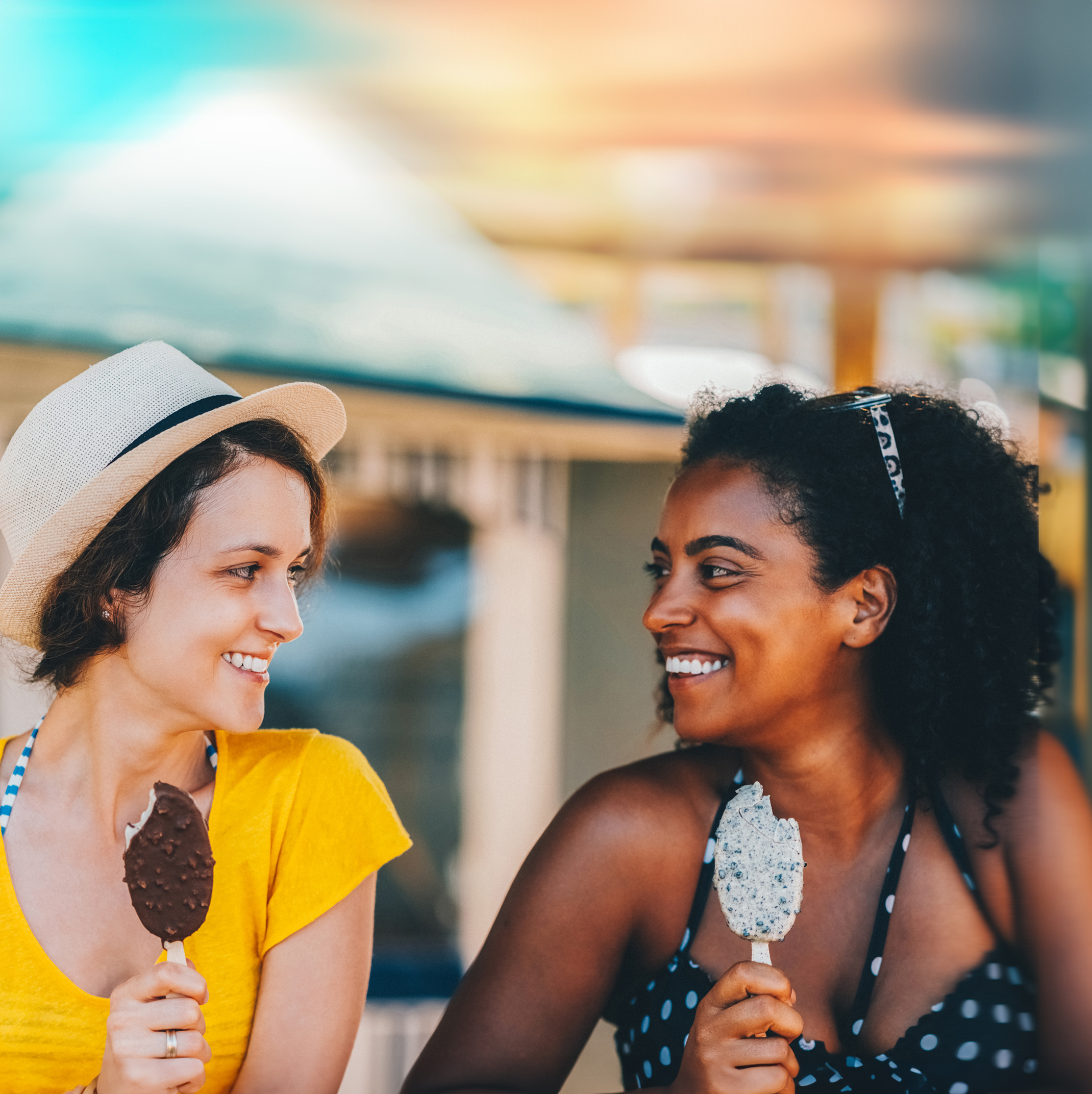 Two Patelco members goofing off together on a sunny beach