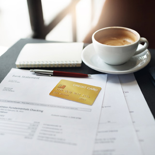 stack of papers with a credit card on top